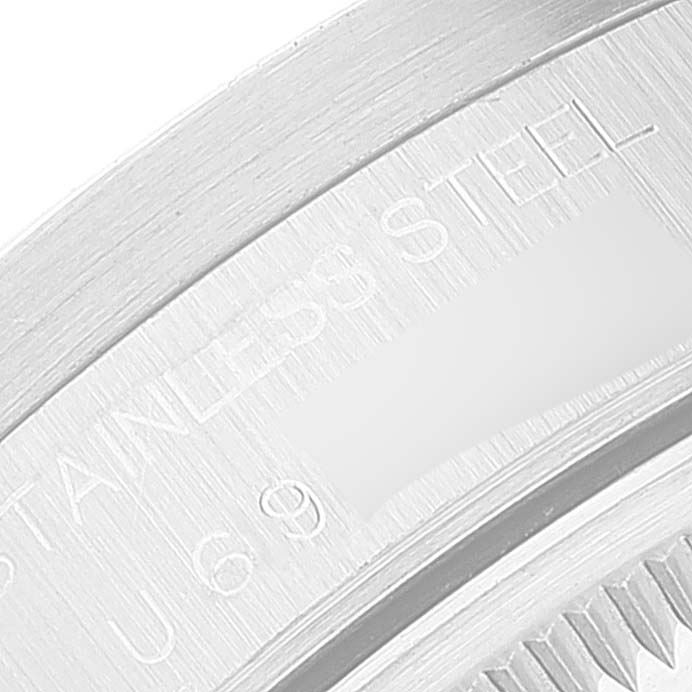 The image shows a close-up of the back case edge of a Rolex Date 15210 Men
s Stainless Steel Black Dial 15210 Men
s Stainless Steel Black Dial model watch, indicating "Stainless Steel."