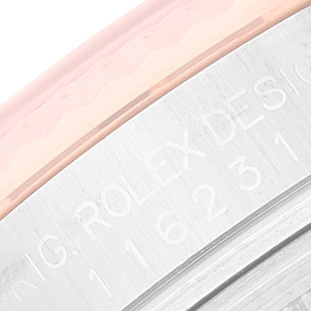 This image shows a close-up of the engraved side view of the bezel and case of a Rolex Datejust 116231 Men's Steel and Gold (two tone) Black Dial 116231 Men's Steel and Gold (two tone) Black Dial watch.