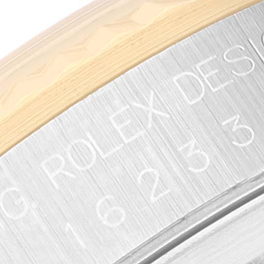 This image shows a close-up of the engraved case side, including the bezel, of a Rolex Datejust 16233 Men's Steel and Gold (two tone) Champagne Dial 16233 Men's Steel and Gold (two tone) Champagne Dial watch.