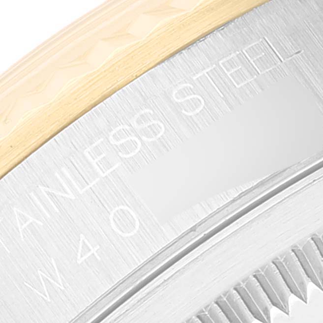 The image shows a close-up of the side of a Rolex Datejust 16233 Men's Steel and Gold (two tone) Champagne Dial 16233 Men's Steel and Gold (two tone) Champagne Dial watch, highlighting the stainless steel part and engraving.
