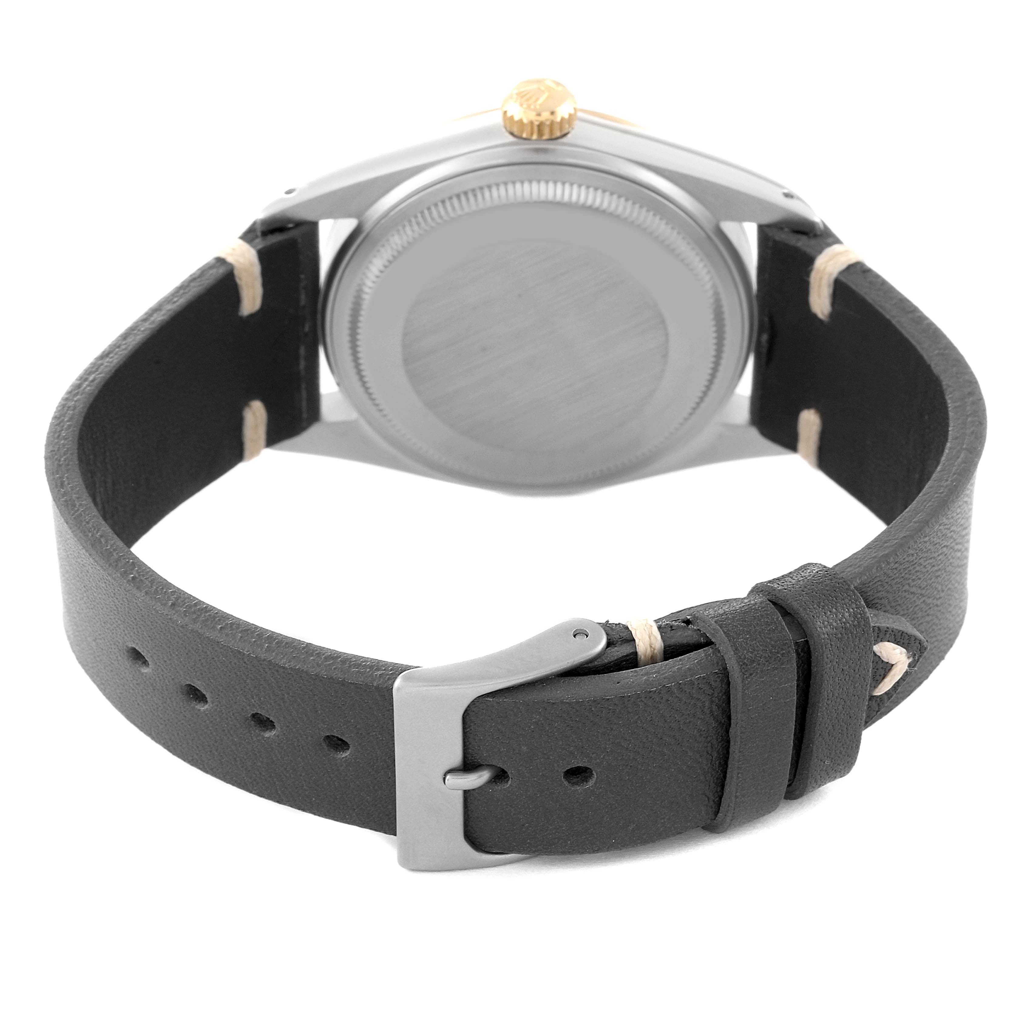 The image shows the back view of a Rolex Vintage Collection 16013 Men's Steel and Gold (two tone) Champagne Dial 16013 Men's Steel and Gold (two tone) Champagne Dial watch, focusing on the case back, crown, and black leather strap with a buckle.