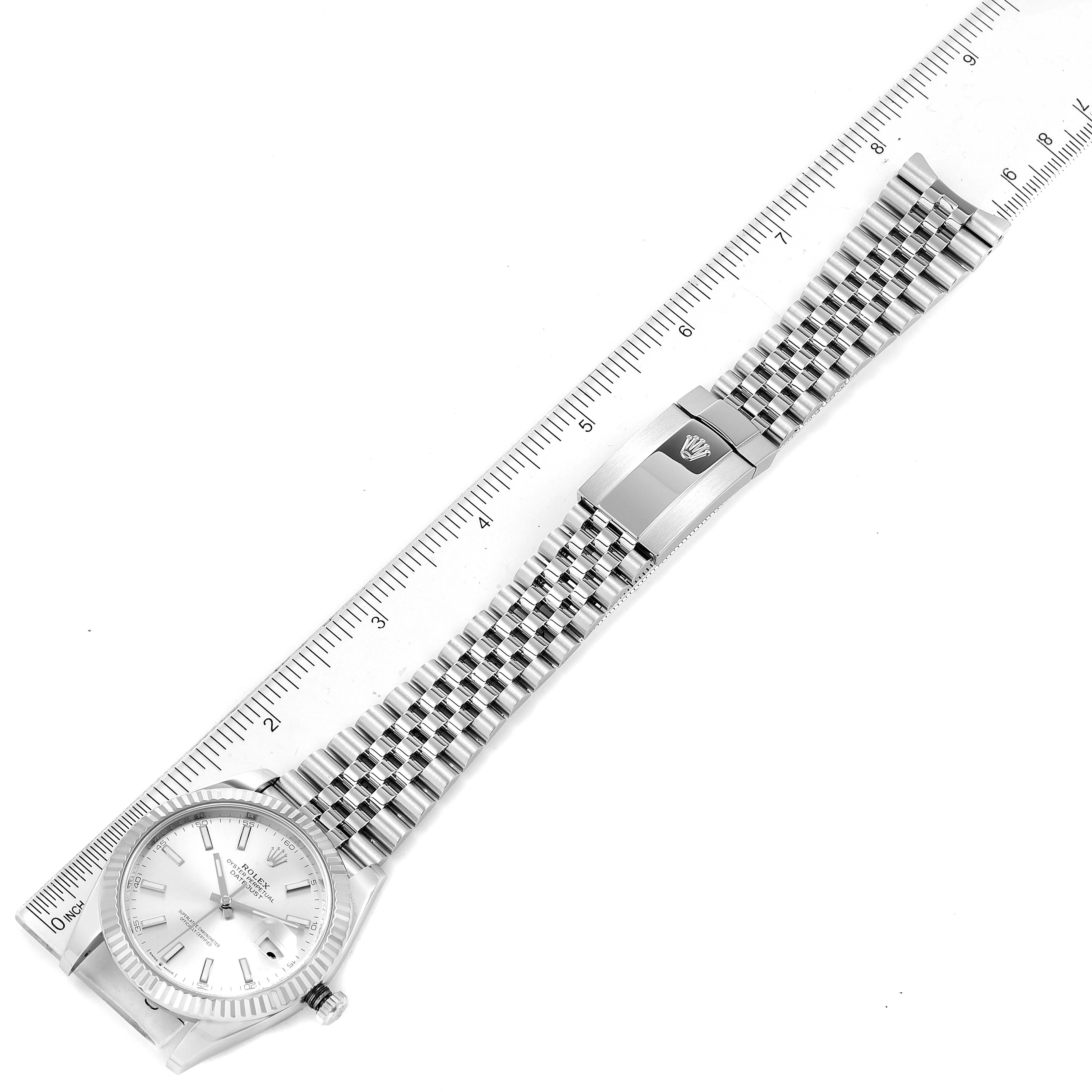 The image shows a top-down view of the Rolex Datejust 41 126334 Men's Stainless Steel Silver Dial 126334 Men's Stainless Steel Silver Dial model, displaying the watch face, bracelet, and clasp next to a measuring ruler.