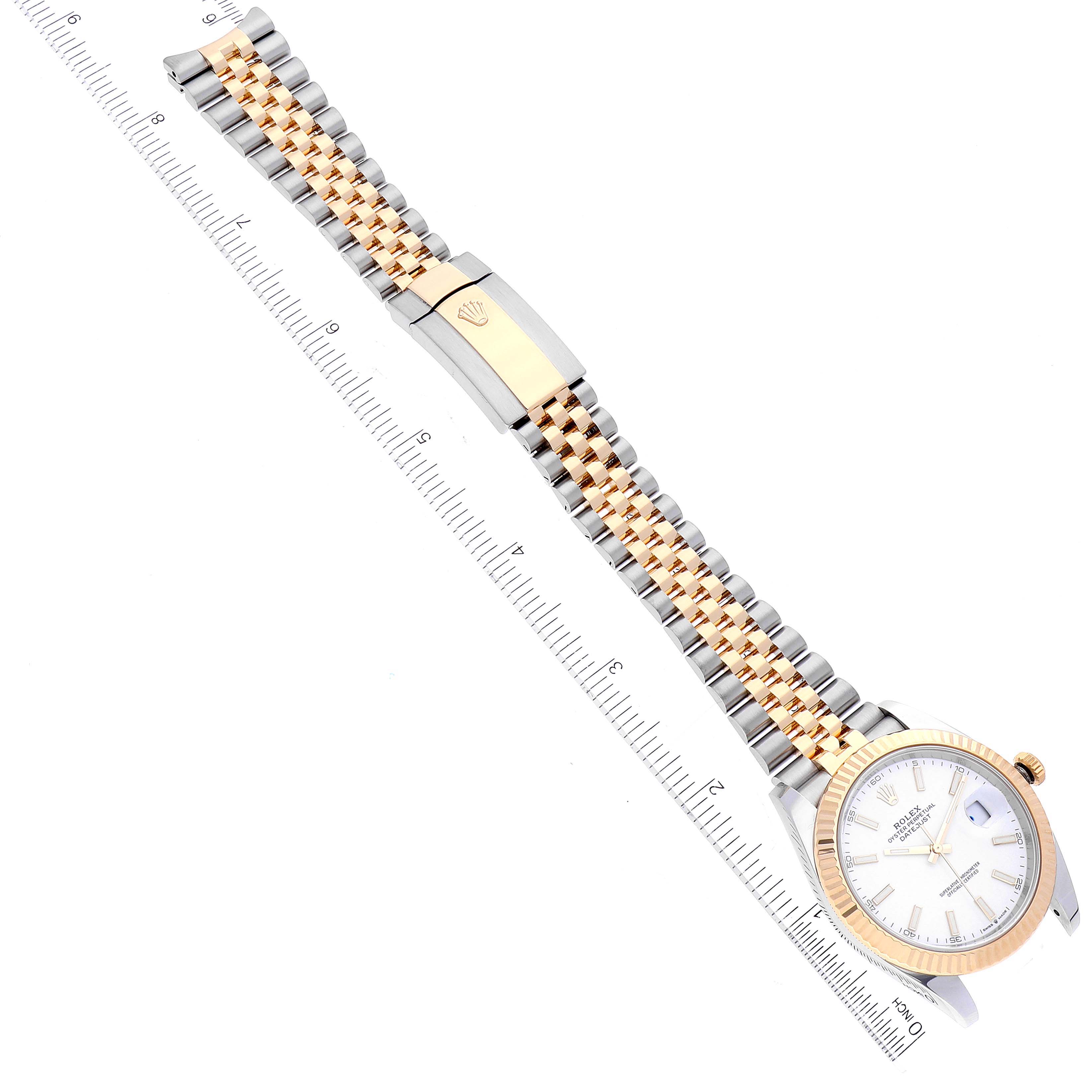 The image shows the Rolex Datejust 41 126333 Men's Steel and Gold (two tone) White Dial 126333 Men's Steel and Gold (two tone) White Dial watch laid flat with its bracelet fully extended and a ruler for scale.