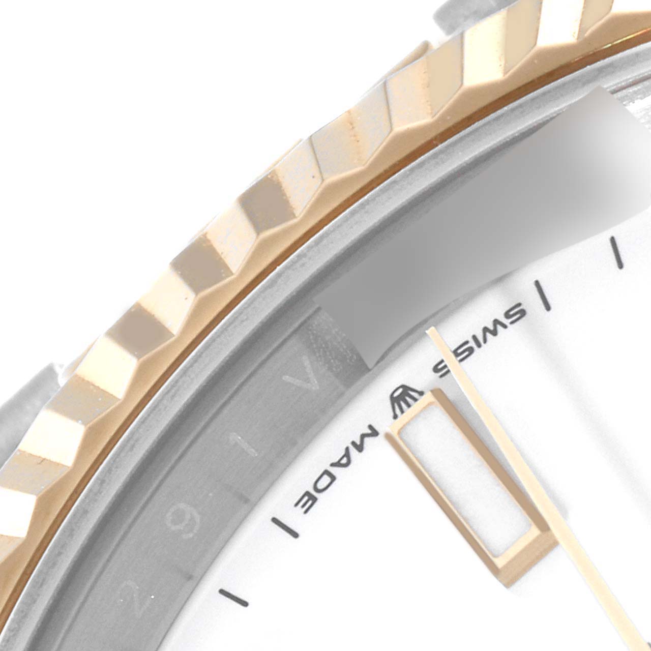 This close-up image of the Rolex Datejust 41 126333 Men's Steel and Gold (two tone) White Dial 126333 Men's Steel and Gold (two tone) White Dial shows part of the bezel, dial, and minute hand.