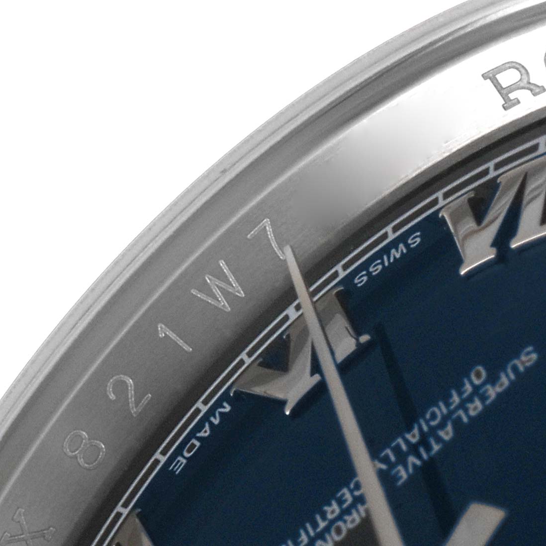This close-up image of a Rolex Datejust 116200 Men's Stainless Steel Blue Dial 116200 Men's Stainless Steel Blue Dial watch shows parts of the bezel, dial, and hour markers viewed from an angled perspective.