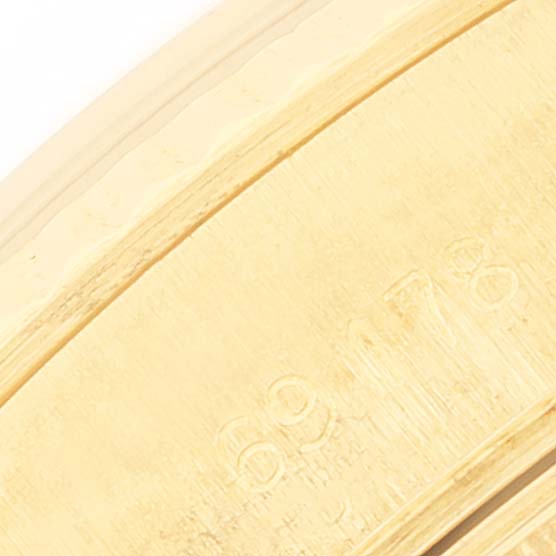 The image shows a close-up of the band of a Rolex President 69178 Women's Yellow Gold Champagne Dial 69178 Women's Yellow Gold Champagne Dial model watch, focusing on numerical engravings.