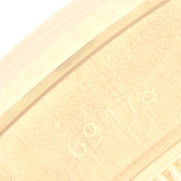 This close-up image shows part of the inner casing of a Rolex President 69178 Women
s Yellow Gold Champagne Dial 69178 Women
s Yellow Gold Champagne Dial watch, including engraved identification numbers.