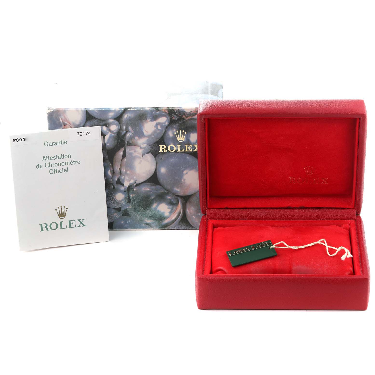 The image shows a Rolex Datejust 79174 Women's Stainless Steel Silver Dial 79174 Women's Stainless Steel Silver Dial model's red watch box, a warranty booklet, and packaging materials.
