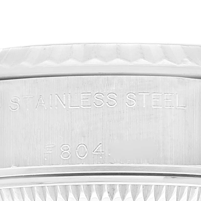 The image shows a close-up of the stainless steel casing with serial engraving on a Rolex Datejust 79174 Women's Stainless Steel Silver Dial 79174 Women's Stainless Steel Silver Dial watch.