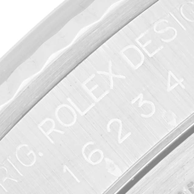 This image shows a close-up of the engraved case side of a Rolex Datejust 16234 Men's Stainless Steel White Dial 16234 Men's Stainless Steel White Dial watch.