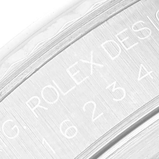 The image shows an angled close-up view of the engraved inner ring with "ROLEX DESIGN" on the Datejust model by Rolex.