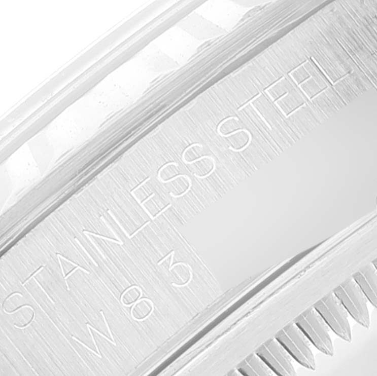 This close-up image shows the engraved "Stainless Steel" text on the side of a Rolex Datejust 16234 Men's Stainless Steel Pink Dial 16234 Men's Stainless Steel Pink Dial watch bezel.