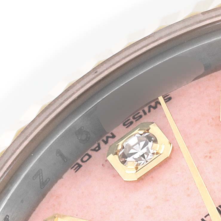 This close-up image shows the bezel and a diamond marker on the dial of a Rolex Datejust 179173 Women's Steel and Gold (two tone) Pink Dial 179173 Women's Steel and Gold (two tone) Pink Dial watch.