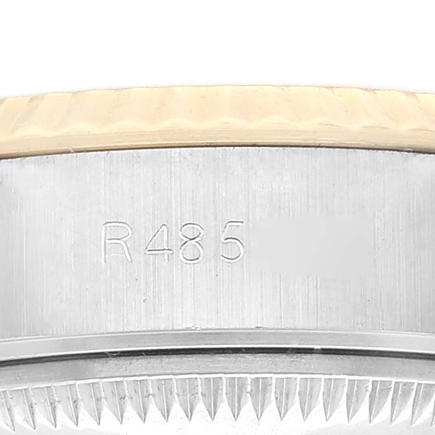 The image shows a close-up of the side of the Rolex Datejust 69173 Women's Steel and Gold (two tone) Champagne Dial 69173 Women's Steel and Gold (two tone) Champagne Dial watch case with engraved model information.