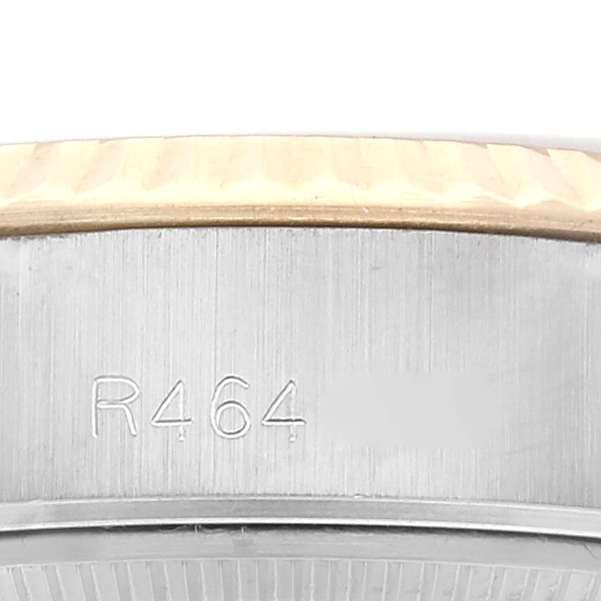 This image shows a close-up of the side of the casing of a Rolex Datejust 69173 Women's Steel and Gold (two tone) Champagne Dial 69173 Women's Steel and Gold (two tone) Champagne Dial watch, featuring its serial number engraving.