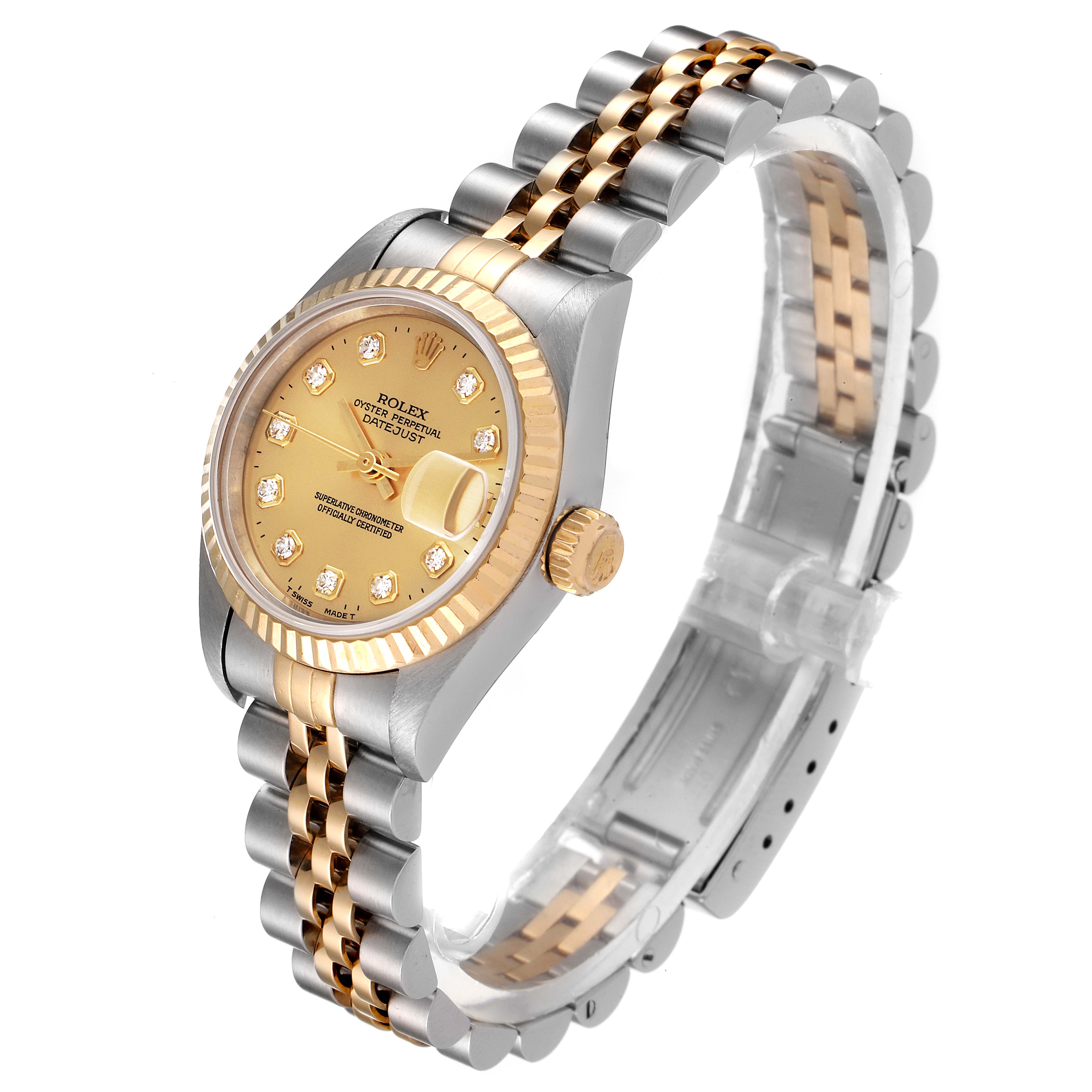 The image shows a Rolex Datejust 79173 Women's Steel and Gold (two tone) Champagne Dial 79173 Women's Steel and Gold (two tone) Champagne Dial watch from a three-quarter angle, highlighting its gold dial, bezel, crown, and two-tone bracelet.