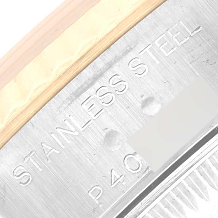 This close-up angle shows the side and part of the bezel of the Rolex Datejust 79173 Women's Steel and Gold (two tone) White Dial 79173 Women's Steel and Gold (two tone) White Dial watch, focusing on the "STAINLESS STEEL" engraving.