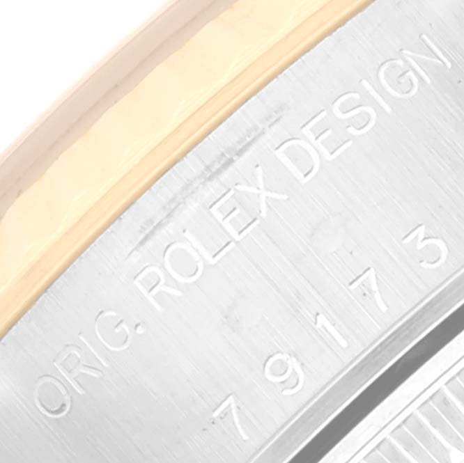 The image shows an angled close-up of the bezel edge and the engraved serial number on the case of a Rolex Datejust 79173 Women's Steel and Gold (two tone) White Dial 79173 Women's Steel and Gold (two tone) White Dial watch.