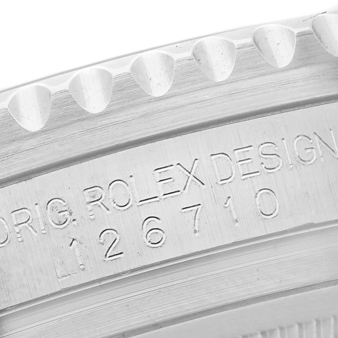 The image shows a close-up of the side engraving on a Rolex GMT-Master 126710BLRO Men's Stainless Steel Black Dial 126710BLRO Men's Stainless Steel Black Dial model, highlighting design and model numbers.