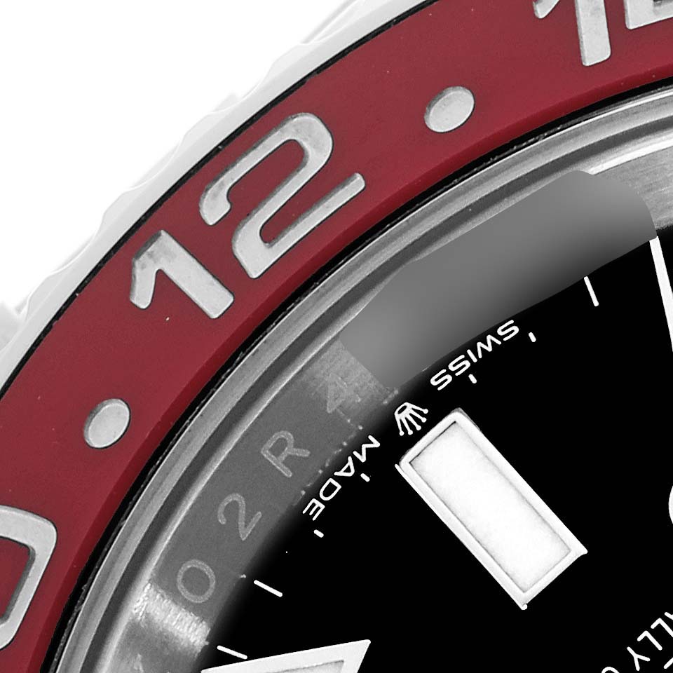The image shows a close-up of the bezel and part of the dial of a Rolex GMT-Master 126710BLRO Men's Stainless Steel Black Dial 126710BLRO Men's Stainless Steel Black Dial watch, with focus on the "12" marker and "Swiss Made" text.