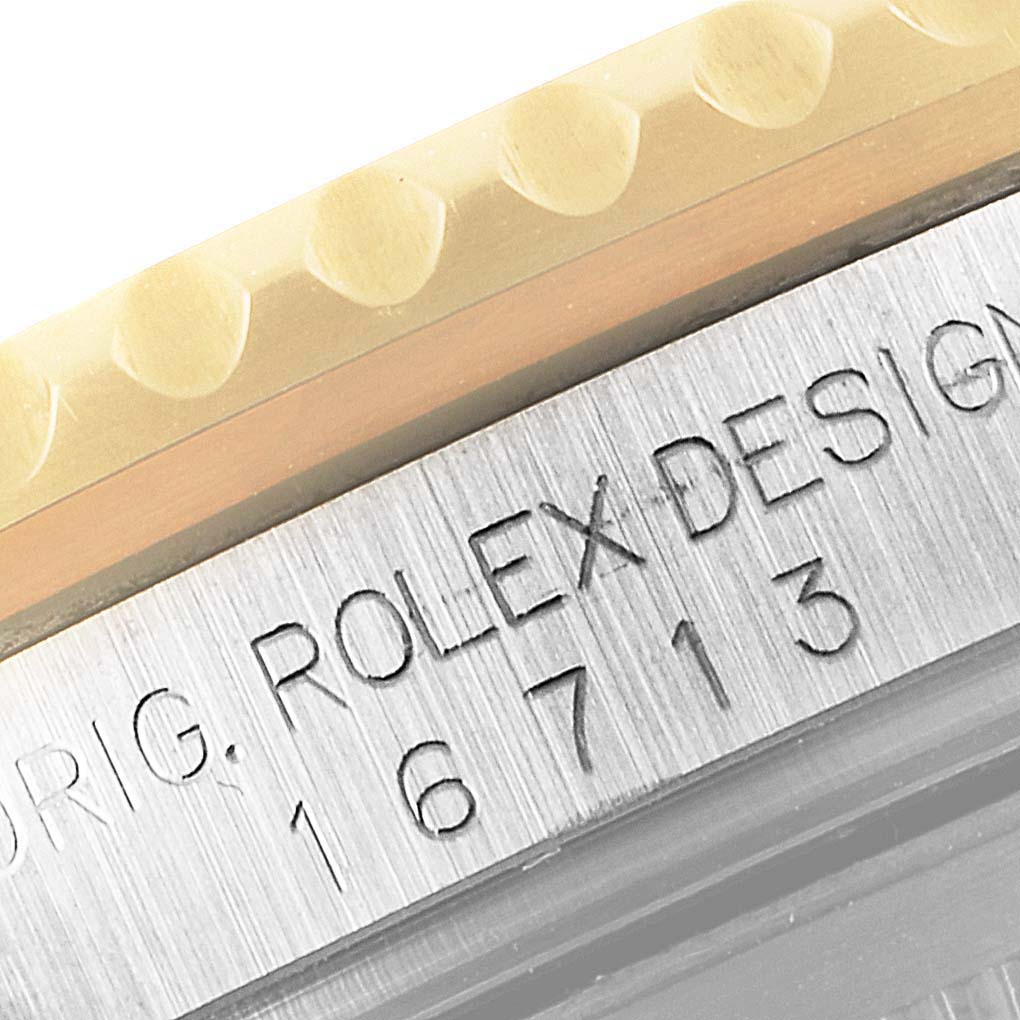 Close-up of the side of a Rolex GMT-Master 16713 Men's Steel and Gold (two tone) Black Dial 16713 Men's Steel and Gold (two tone) Black Dial, showing the model number 16713 etched on the case.