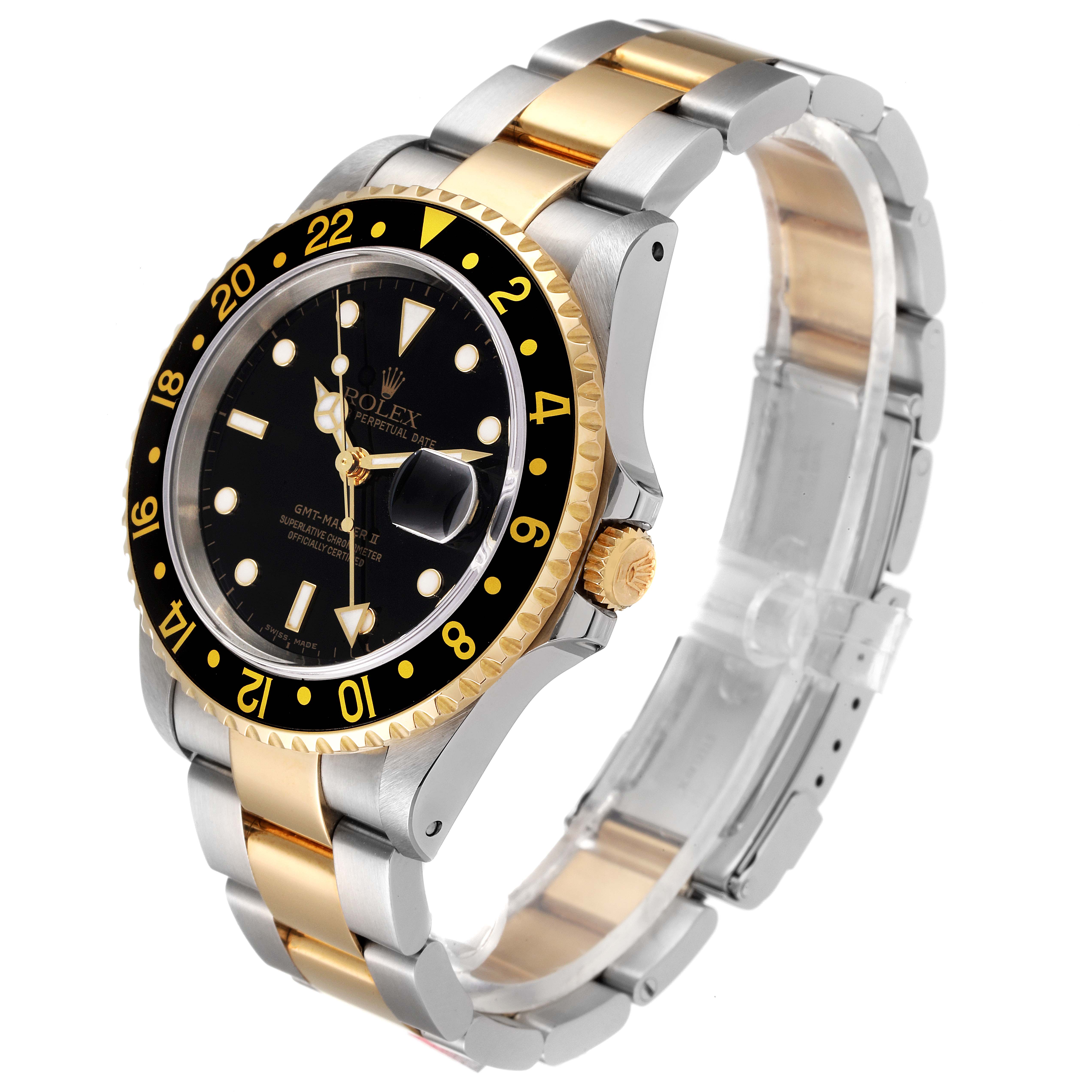 The image shows a three-quarter angle of a Rolex GMT-Master 16713 Men's Steel and Gold (two tone) Black Dial 16713 Men's Steel and Gold (two tone) Black Dial II, highlighting its black dial, gold accents, and two-tone bracelet.