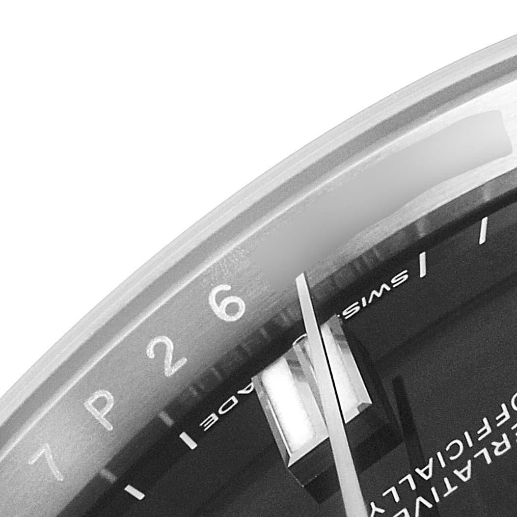 This close-up image displays a partial view of the dial and bezel of the Rolex Oyster Perpetual 126000 Men
s Stainless Steel Black Dial 126000 Men
s Stainless Steel Black Dial watch.
