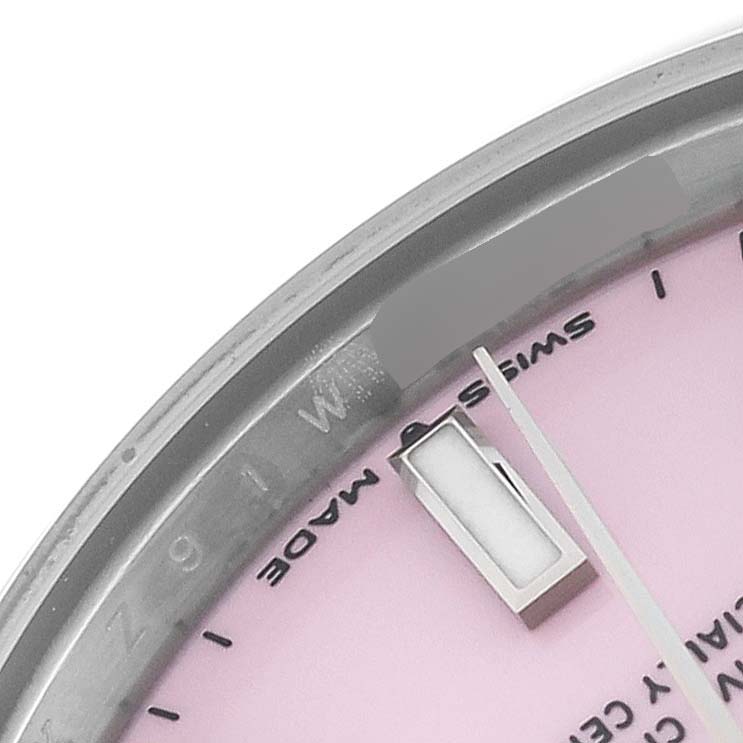 The image shows a close-up view of the dial, partial bezel, and hands of a mid-size Rolex watch.