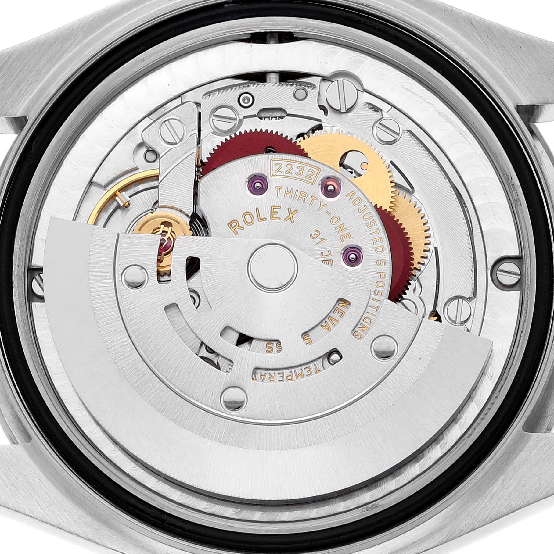 The image shows the inner workings of a Rolex Mid-Size 277200 Women's Stainless Steel Pink Dial 277200 Women's Stainless Steel Pink Dial model, focusing on its intricate mechanical movement from the back.
