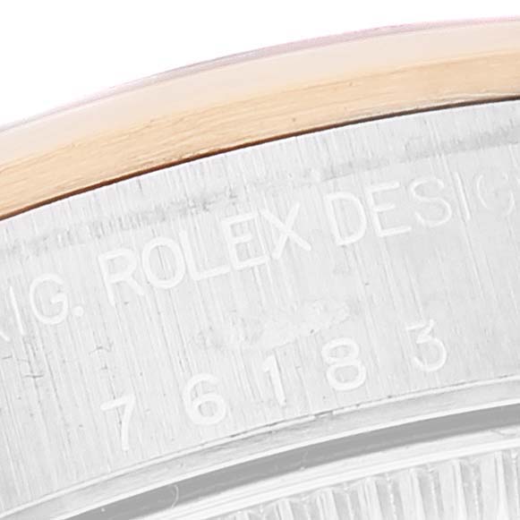 This close-up shows the engraved case back edge of a Rolex Oyster Perpetual 76183 Women's Steel and Gold (two tone) Grey Dial 76183 Women's Steel and Gold (two tone) Grey Dial watch, revealing part of the model number.