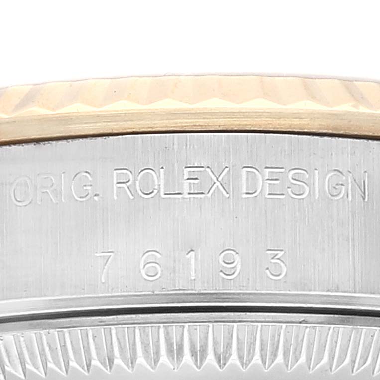 The image shows a close-up of the case side of the Rolex Oyster Perpetual 76193 Women's Steel and Gold (two tone) Black Dial 76193 Women's Steel and Gold (two tone) Black Dial watch, highlighting the engraved model number "76193."