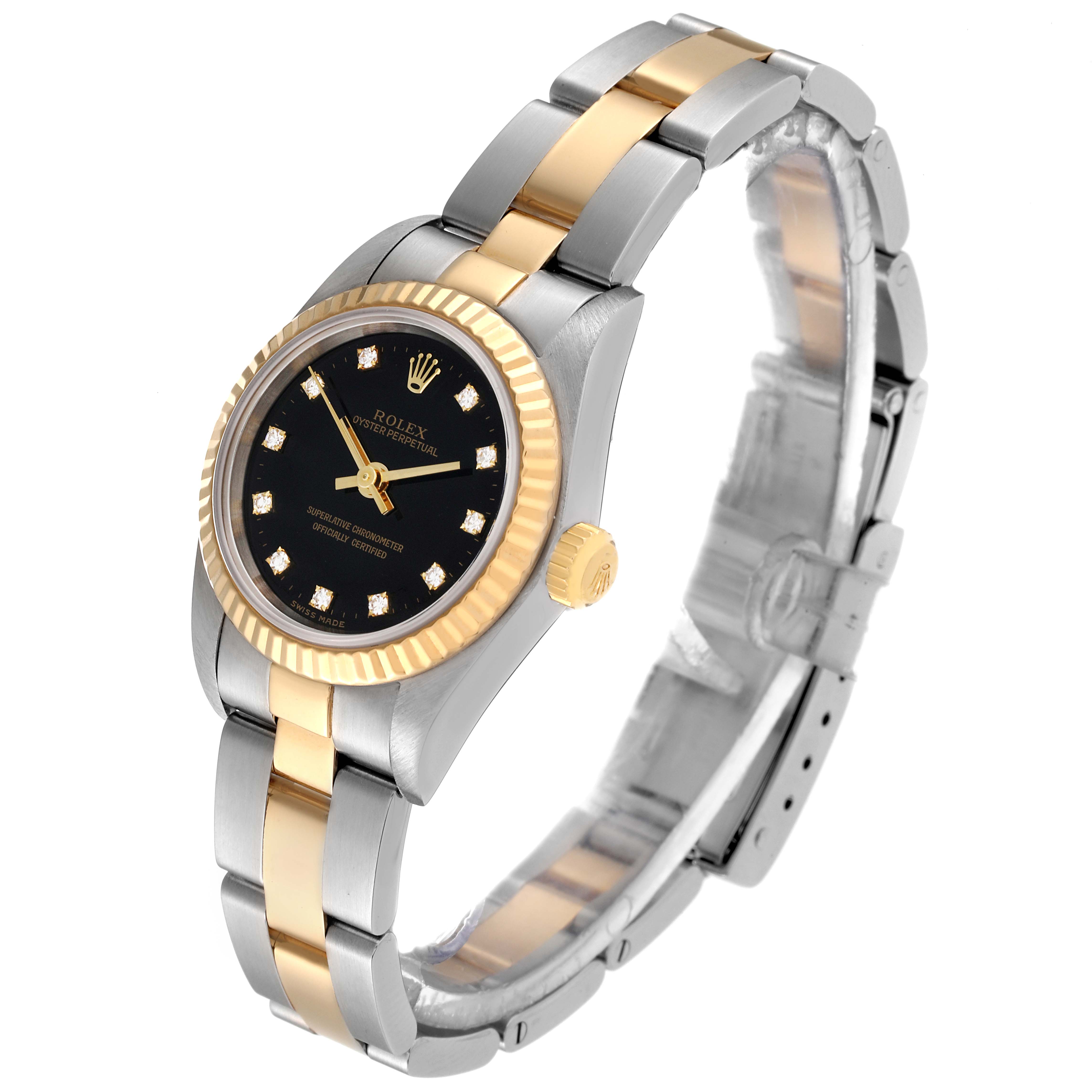 This Rolex Oyster Perpetual 76193 Women's Steel and Gold (two tone) Black Dial 76193 Women's Steel and Gold (two tone) Black Dial is shown at a three-quarter angle, displaying its two-tone bracelet, black dial, and fluted bezel.