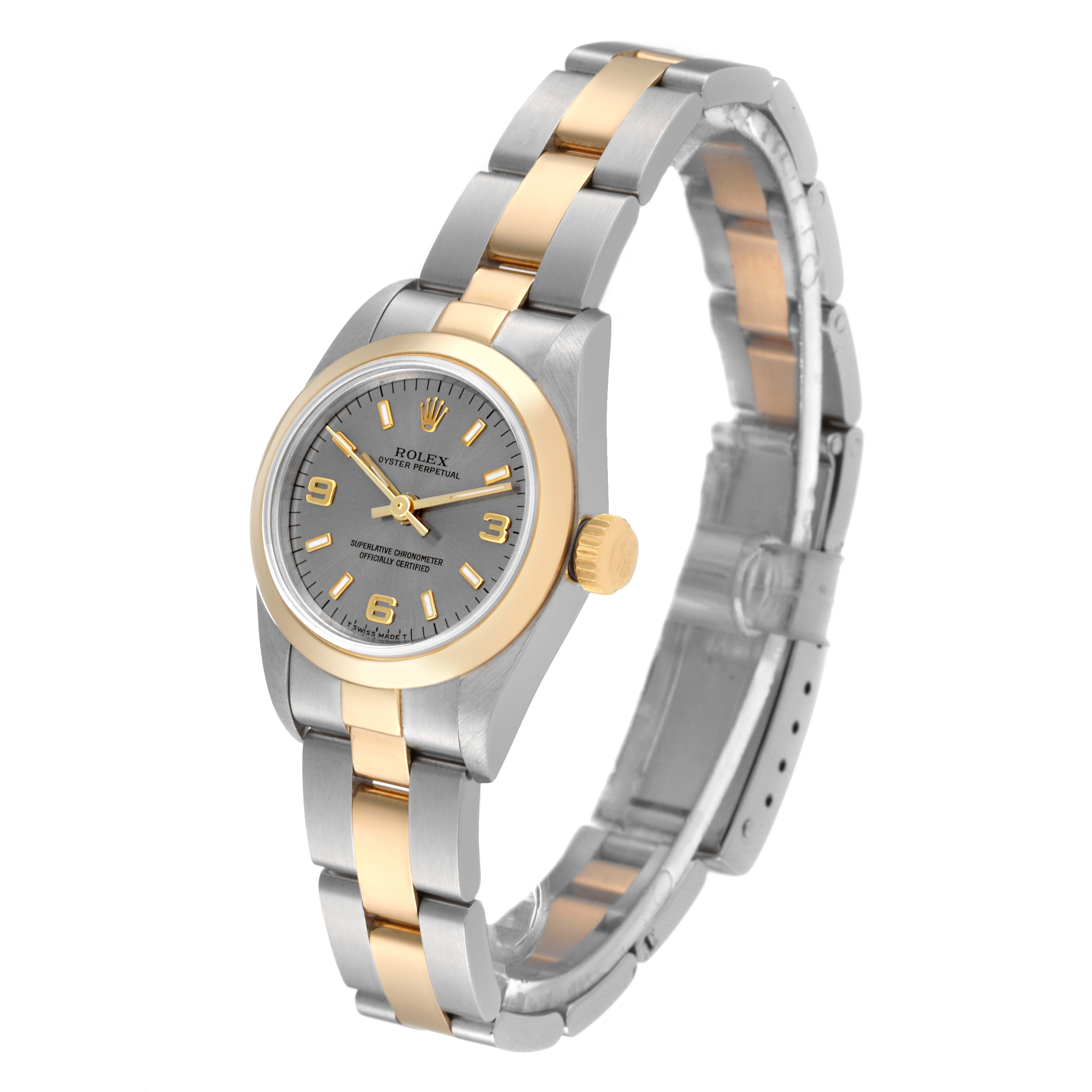The image shows a Rolex Oyster Perpetual 67183 Women's Steel and Gold (two tone) Grey Dial 67183 Women's Steel and Gold (two tone) Grey Dial watch from a front-left angle, highlighting its bezel, dial, and two-tone bracelet.