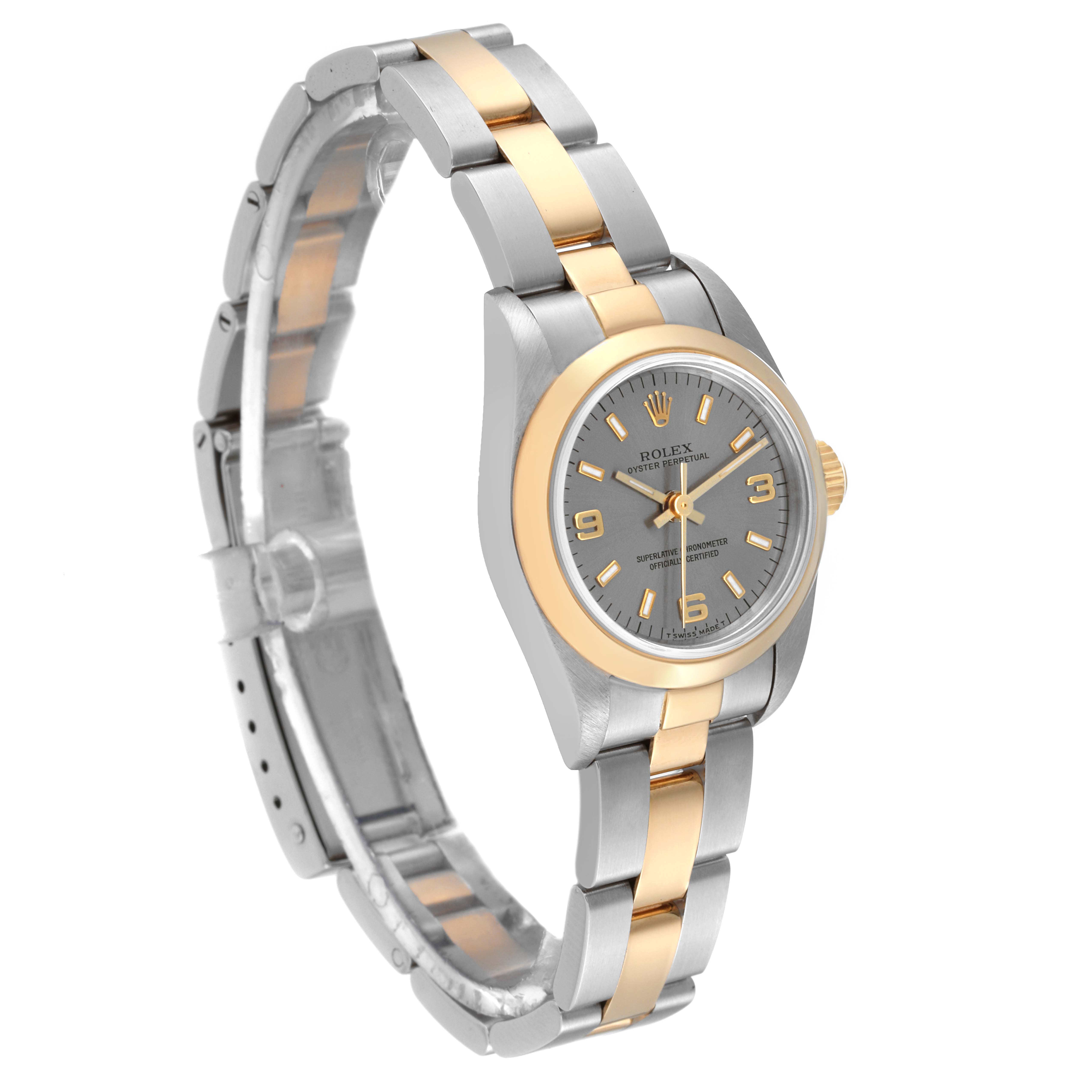 The Rolex Oyster Perpetual 67183 Women's Steel and Gold (two tone) Grey Dial 67183 Women's Steel and Gold (two tone) Grey Dial watch is shown from a three-quarter angle, displaying its dial, bezel, and two-tone bracelet.