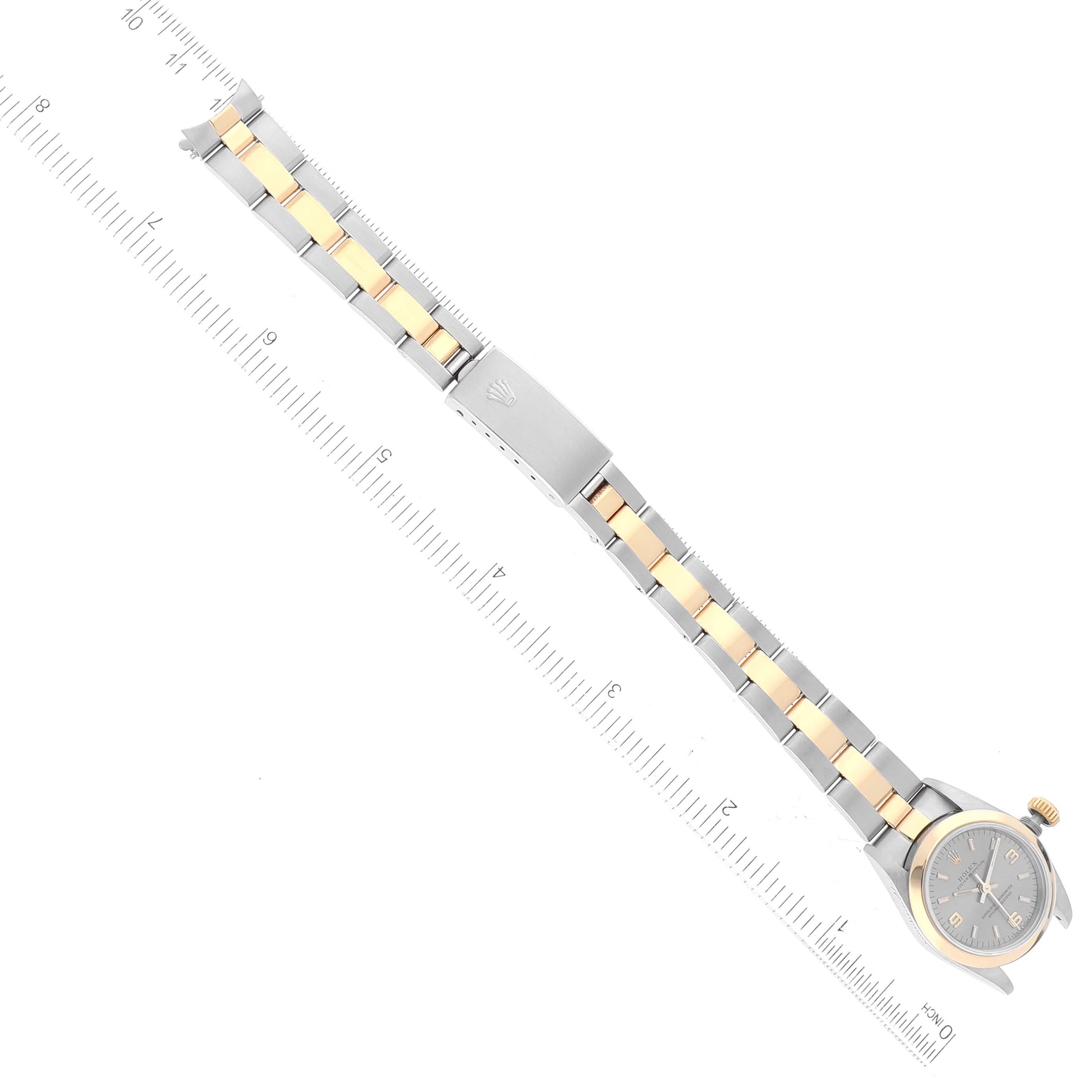 The image shows a top-down view of a Rolex Oyster Perpetual 67183 Women's Steel and Gold (two tone) Grey Dial 67183 Women's Steel and Gold (two tone) Grey Dial watch, highlighting the bracelet and clasp.