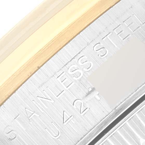 This image shows a close-up of the stainless steel case back with the serial engraving of a Rolex Oyster Perpetual 67183 Women's Steel and Gold (two tone) Grey Dial 67183 Women's Steel and Gold (two tone) Grey Dial watch.