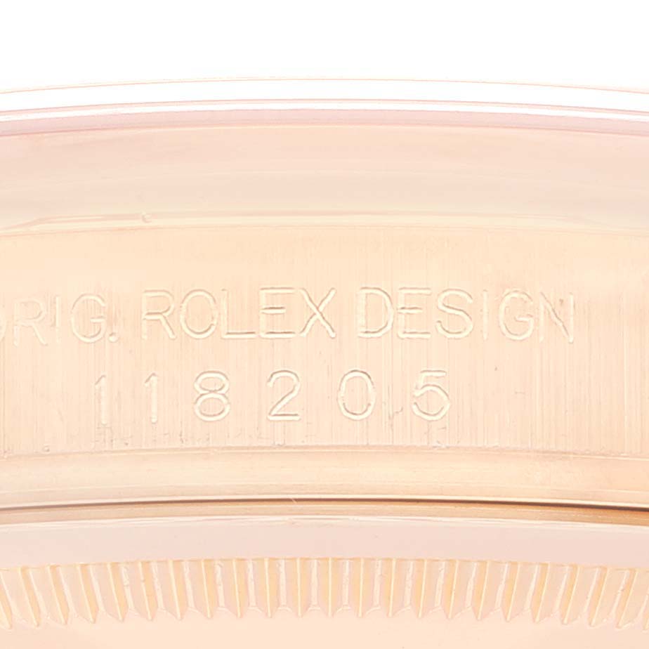 This image shows the engraved case back with the model number of a Rolex President 118205 Men
s Rose Gold Black Dial 118205 Men
s Rose Gold Black Dial watch.