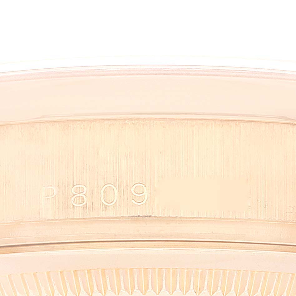 Close-up of the side of the Rolex President 118205 Men
s Rose Gold Black Dial 118205 Men
s Rose Gold Black Dial watch, showing part of the case and engraved model number.