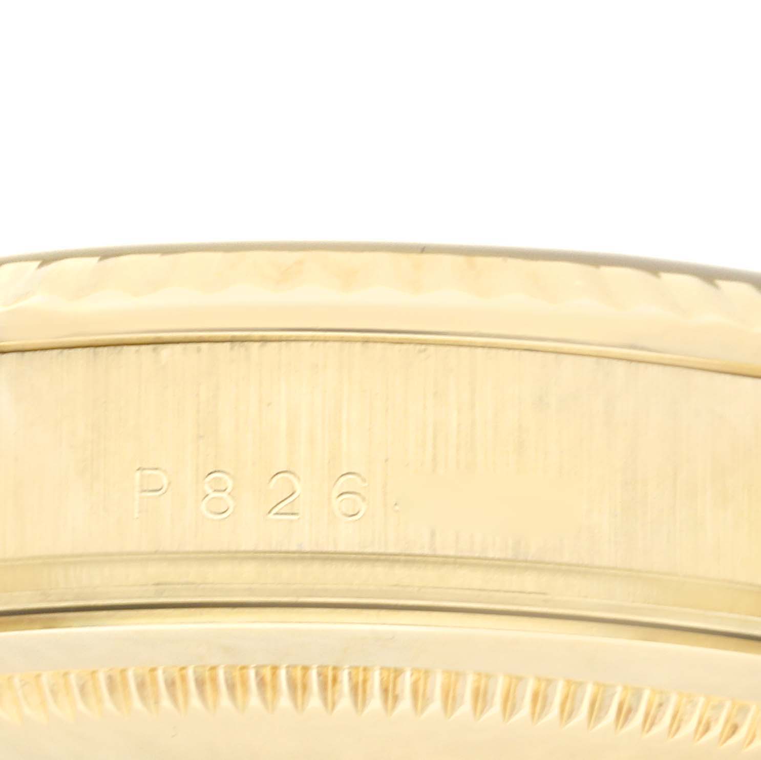 The image shows a close-up of the side of a Rolex President 118238 Men
s Yellow Gold Champagne Dial model watch case, highlighting its serial number and bezel edge.