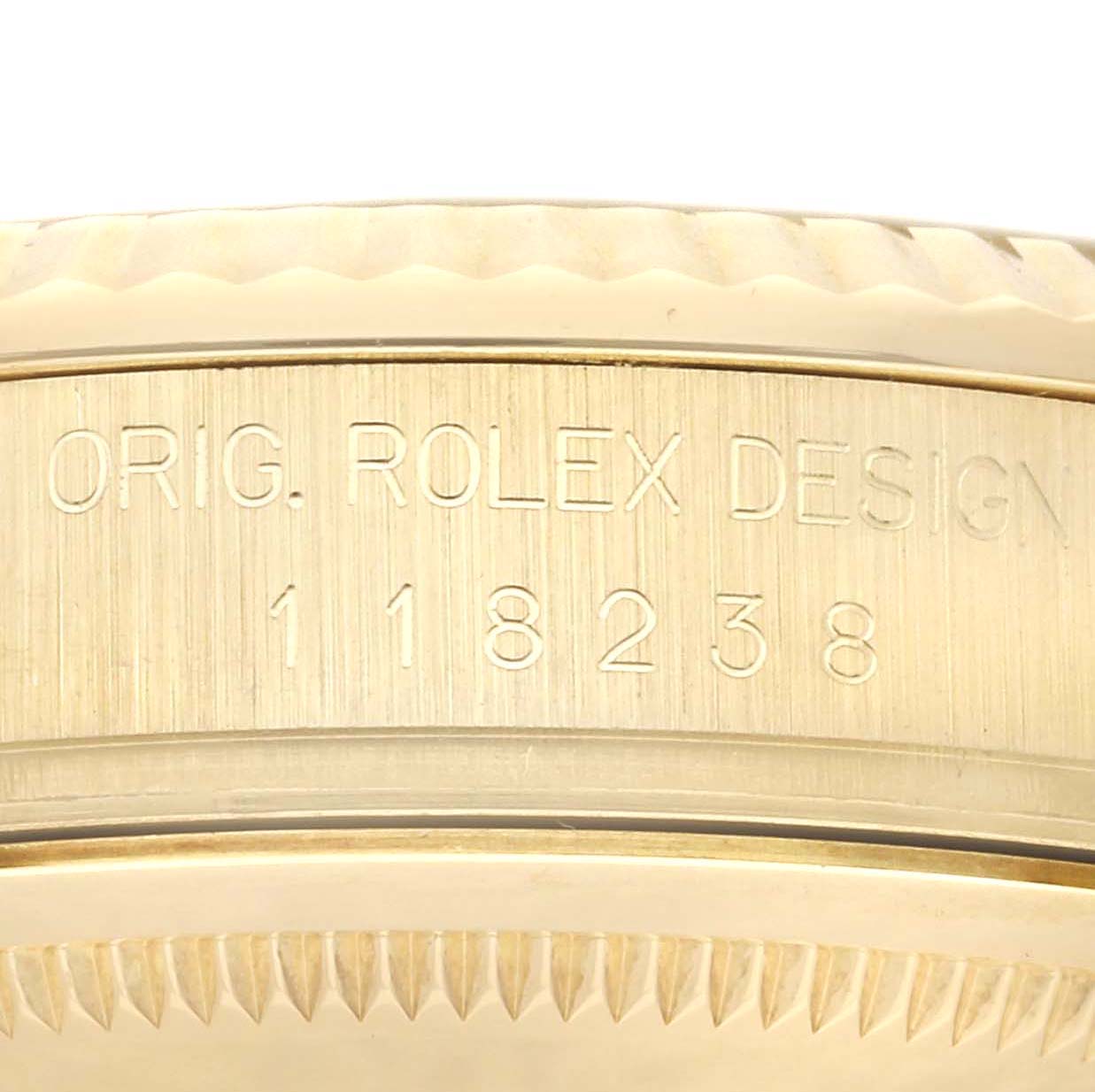 The image shows the side profile of the case showcasing the "ORIG. ROLEX DESIGN 118238" engraved on a Rolex President 118238 Men
s Yellow Gold Champagne Dial model.
