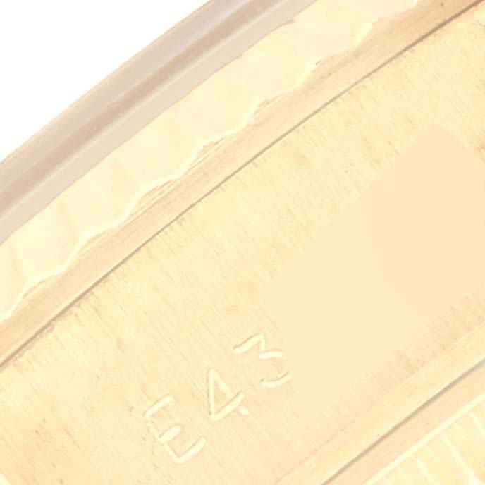 This image shows a close-up angle of the bezel and part of the engraved serial number on the Rolex President 69178 Women's Yellow Gold Champagne Dial 69178 Women's Yellow Gold Champagne Dial model.