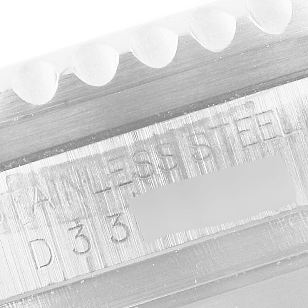 This close-up image shows the engraved text on the brushed metal side of a Rolex Sea-Dweller 16600 Men
s Stainless Steel Black Dial 16600 Men
s Stainless Steel Black Dial watch.