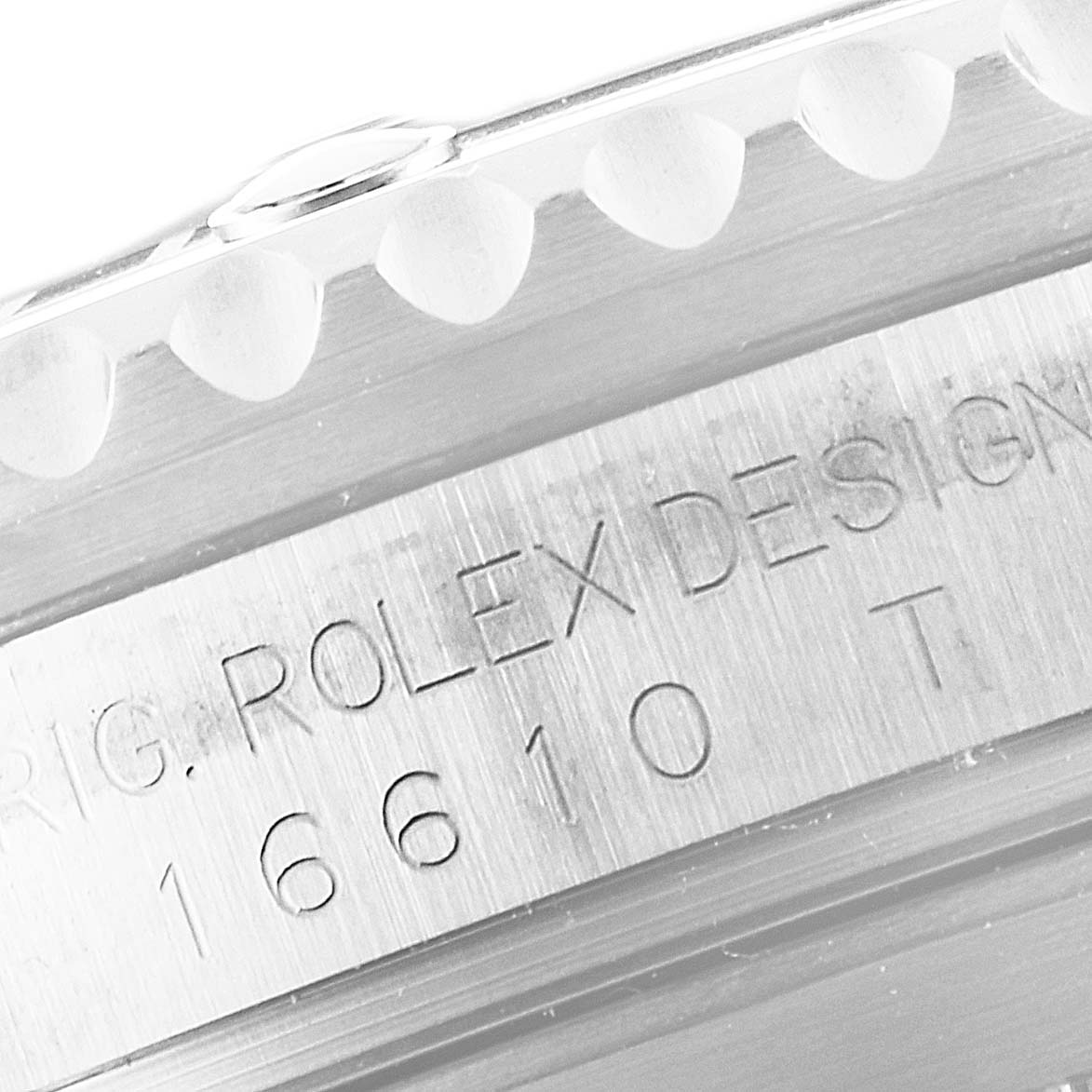 Close-up angle of the case side of a Rolex Submariner 16610 Men
s Stainless Steel Black Dial 16610 Men
s Stainless Steel Black Dial, showing the model number and "ROLEX DESIGN" engraving.