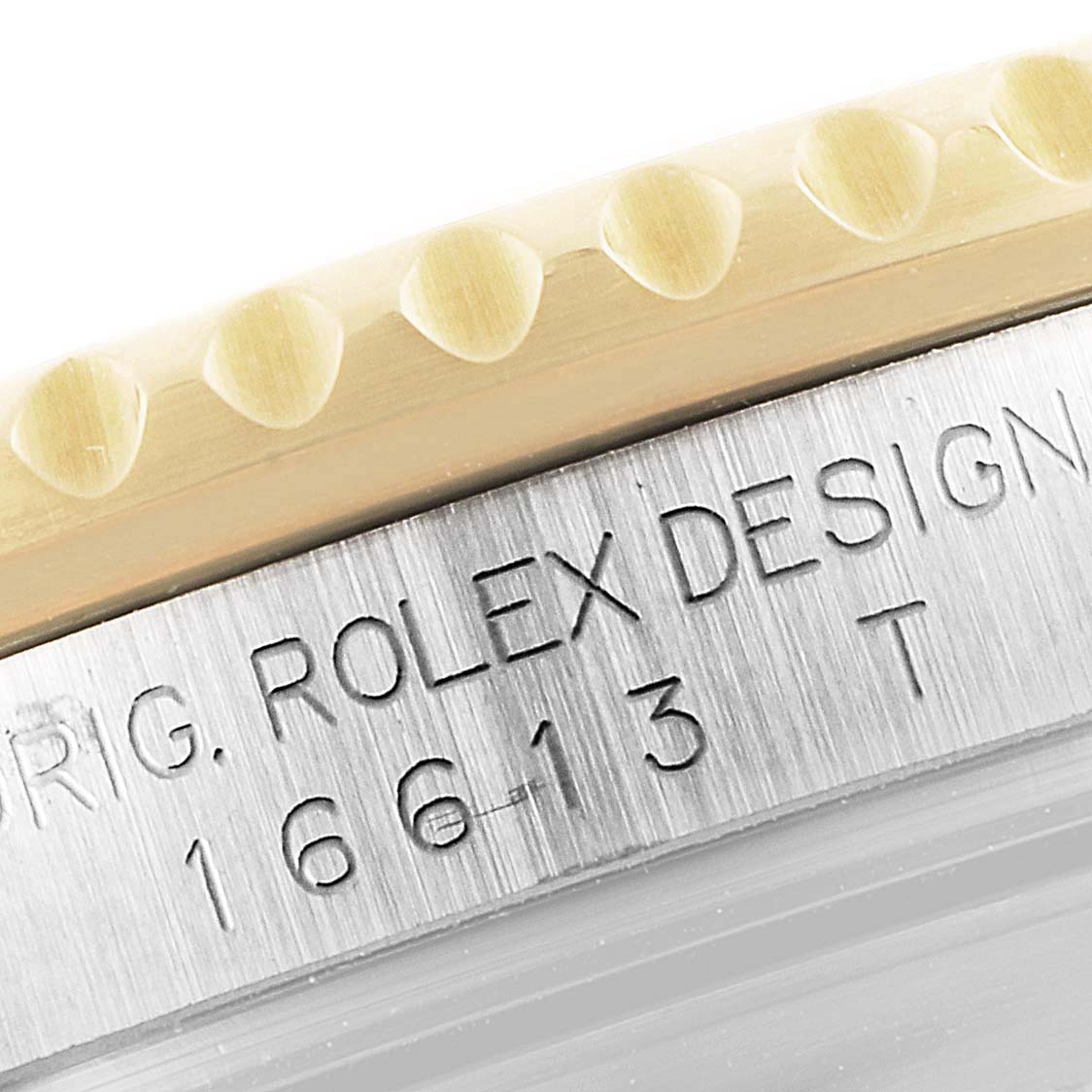 Close-up of a Rolex Submariner 16613 Men's Steel and Gold (two tone) Black Dial 16613 Men's Steel and Gold (two tone) Black Dial showing the engraved serial number and part of the bezel.