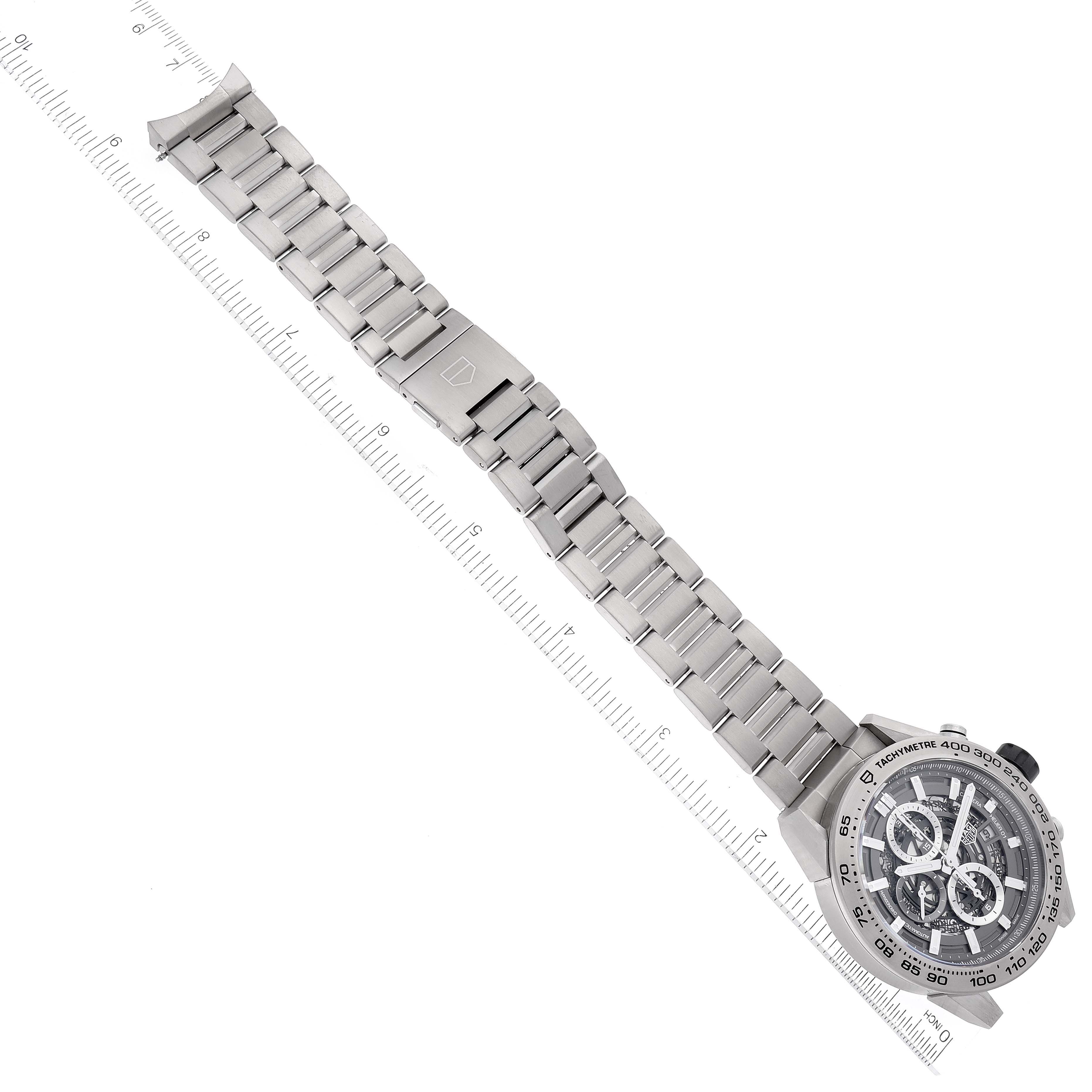 The Tag Heuer Carrera CAR2A8A.BF0707 Men's Titanium Grey Dial CAR2A8A.BF0707 Men's Titanium Grey Dial watch is shown from the top angle, displaying its full metal bracelet and face with a measure scale alongside.