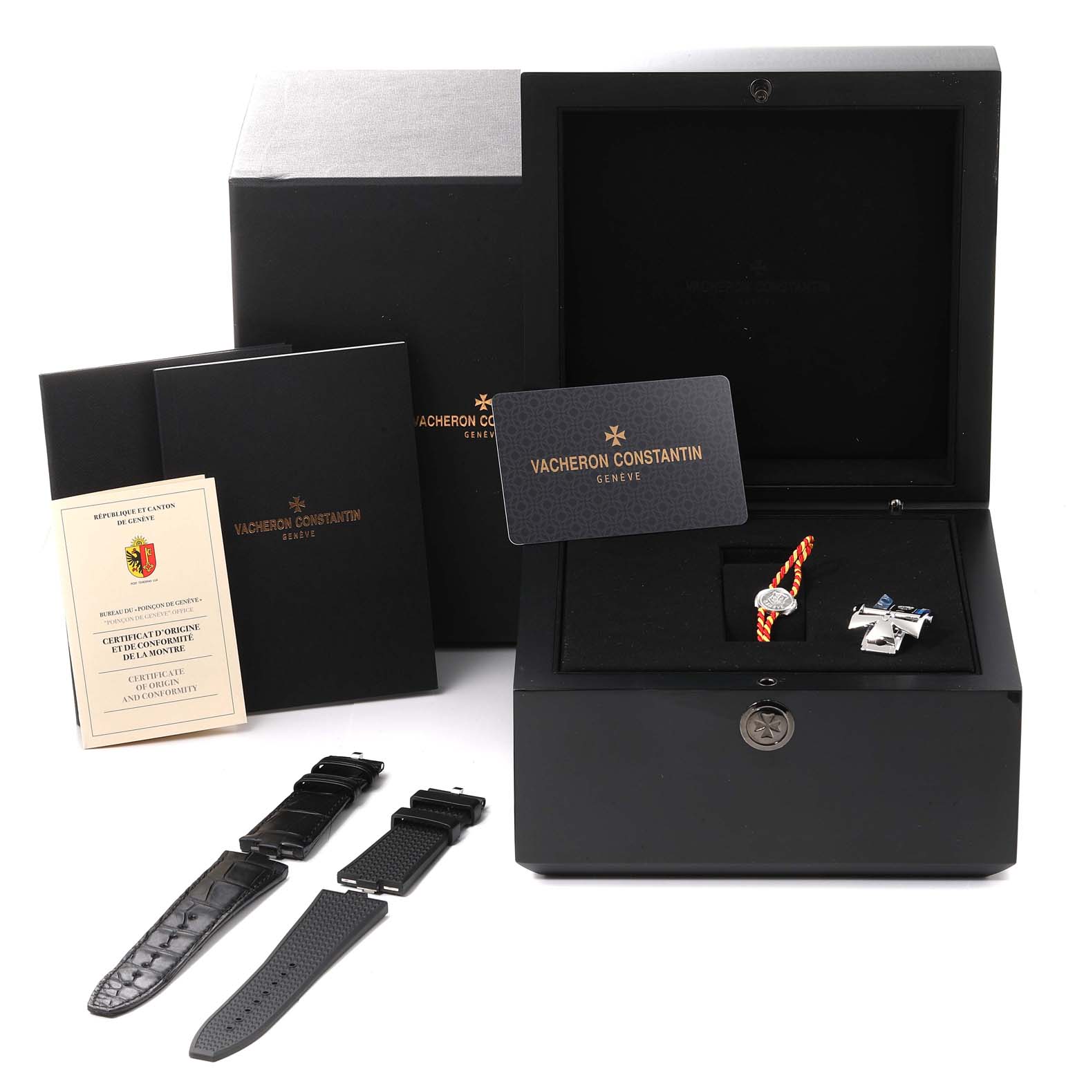 The image shows the Vacheron Constantin Overseas 7900V/110A Men
s Stainless Steel Black Dial 7900V/110A Men
s Stainless Steel Black Dial watch box, additional straps, manuals, certificates, and accessories from a top angle.