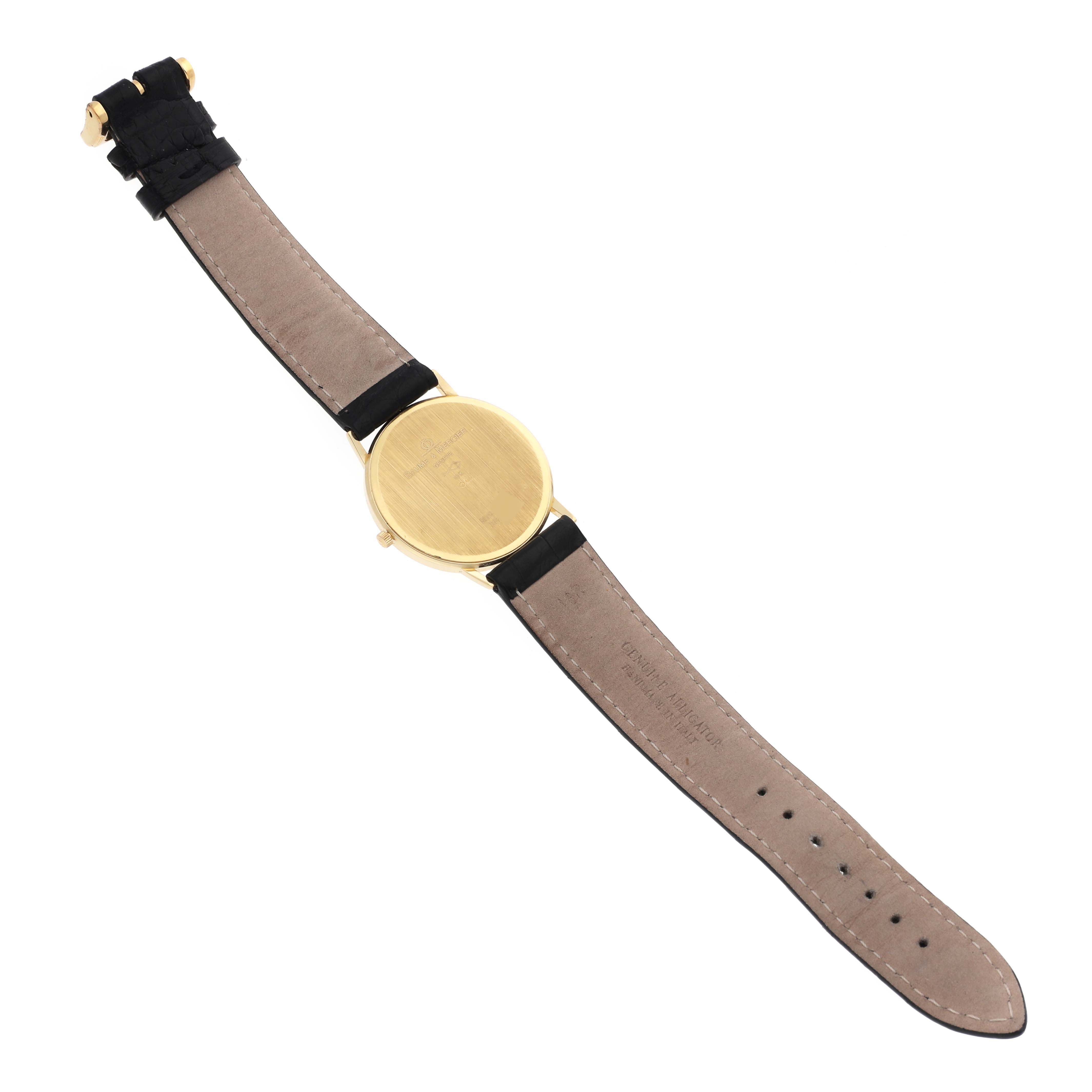 The image shows the back of the Baume & Mercier Classima MV045088 Men's Yellow Gold White Dial MV045088 Men's Yellow Gold White Dial watch, displaying its strap and case.