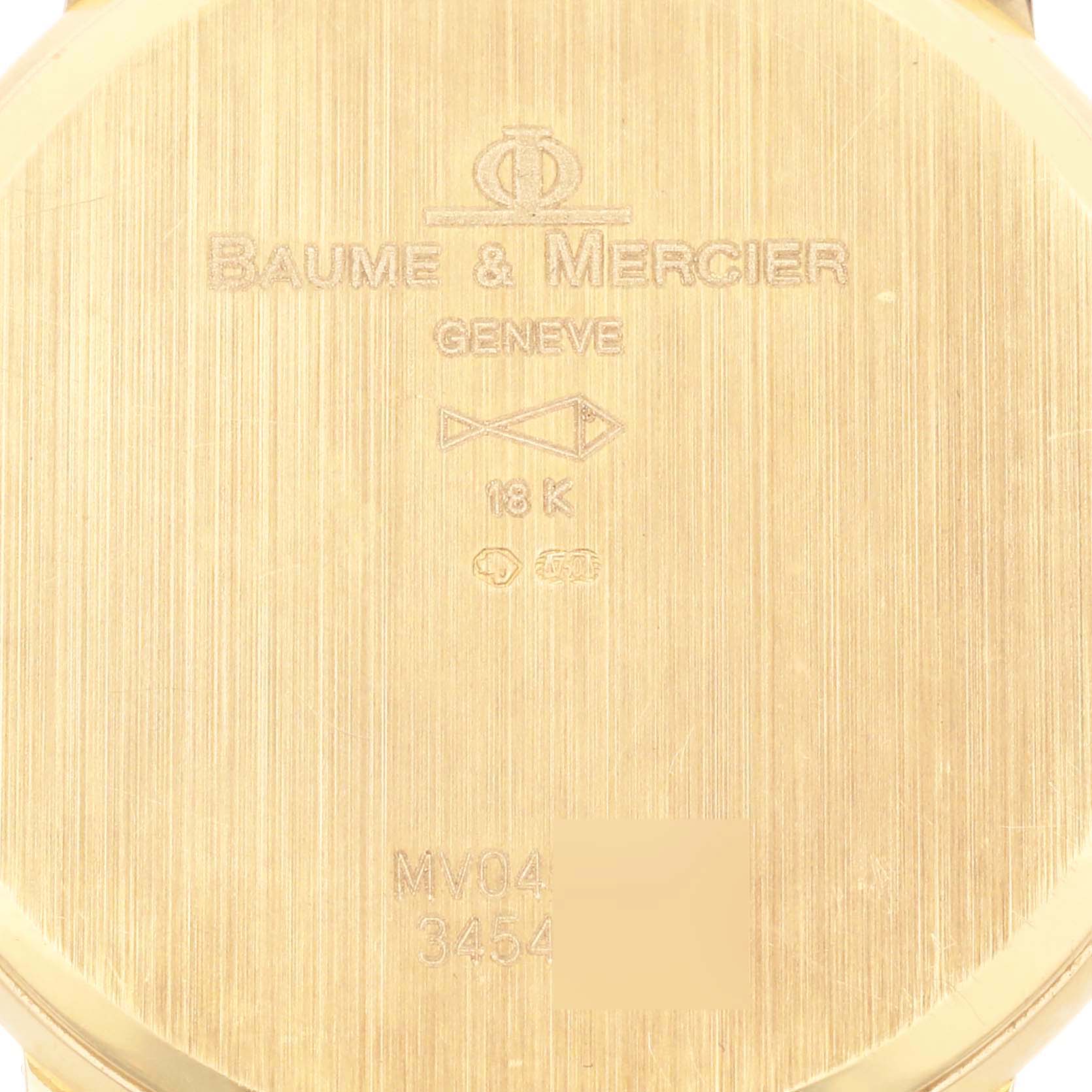 The image shows the back of the Baume & Mercier Classima MV045088 Men's Yellow Gold White Dial MV045088 Men's Yellow Gold White Dial watch case with engraved details.