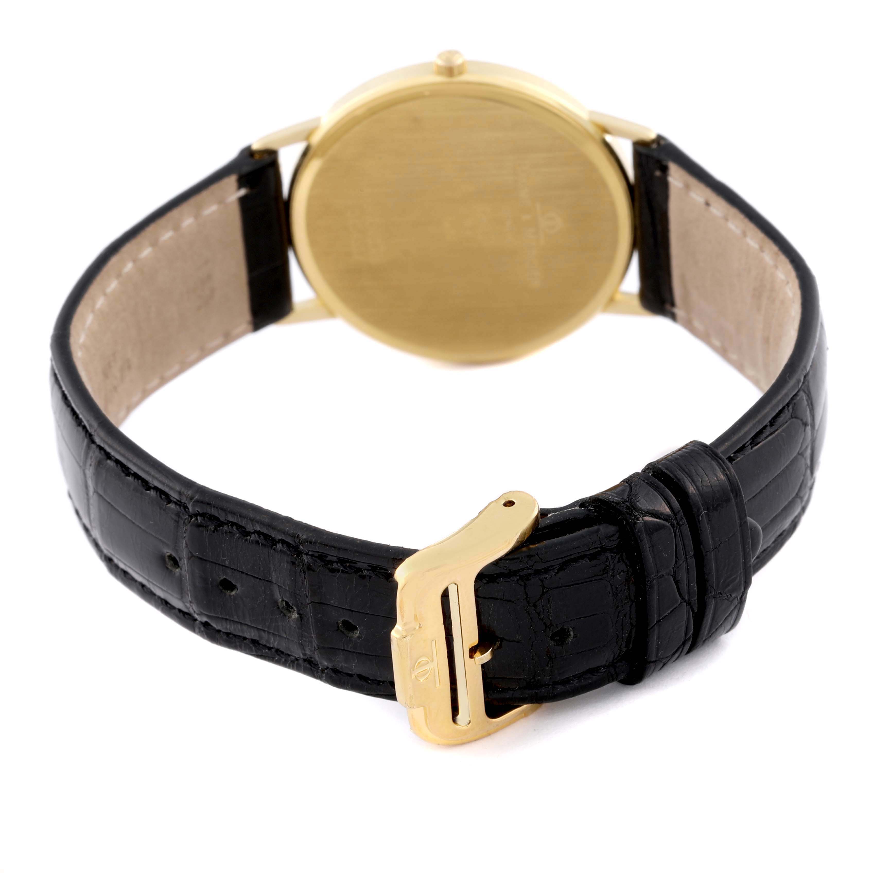 The Baume & Mercier Classima MV045088 Men's Yellow Gold White Dial MV045088 Men's Yellow Gold White Dial watch is shown from the back, highlighting the gold caseback and black leather strap with a gold buckle.