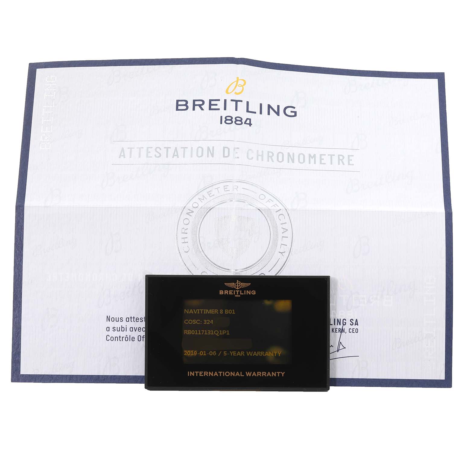The image shows an international warranty card and certificate for a Breitling Navitimer model.